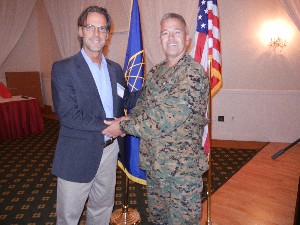 In November, Col. James Turner, USMC (r), chapter president, welcomes guest speaker Dr. Robert Popp, founder, president and chief executive officer of NSI Incorporated.